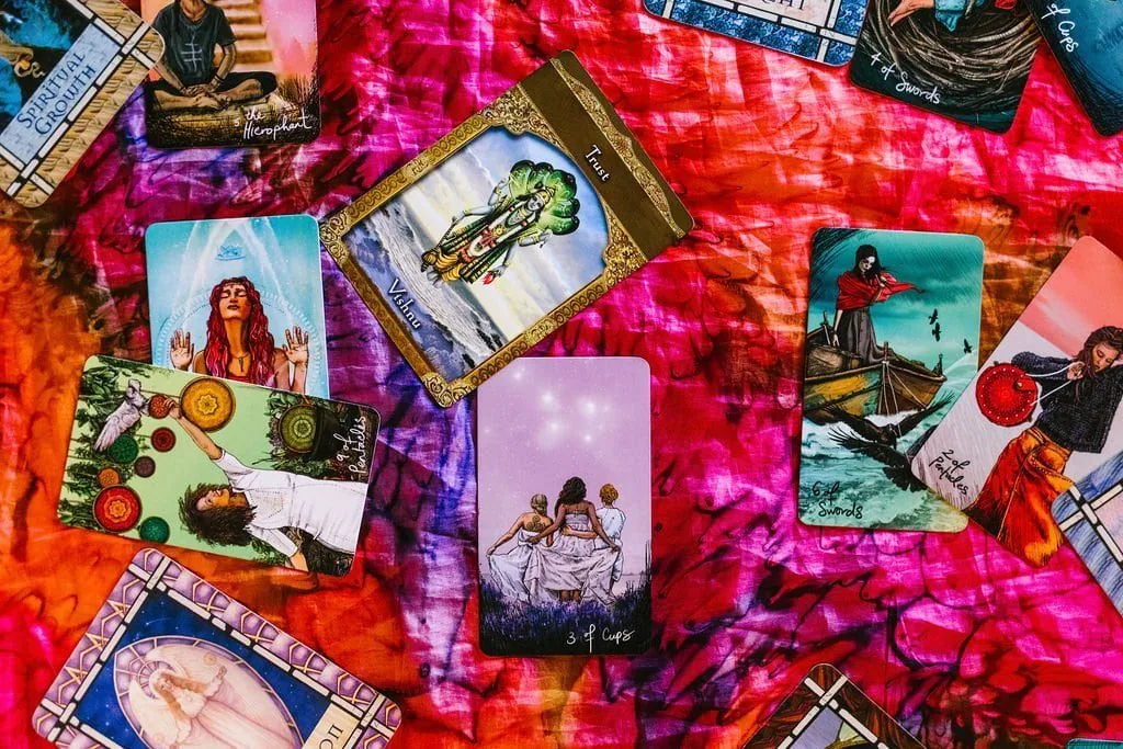 tarot cards laid out on a bright colored cloth