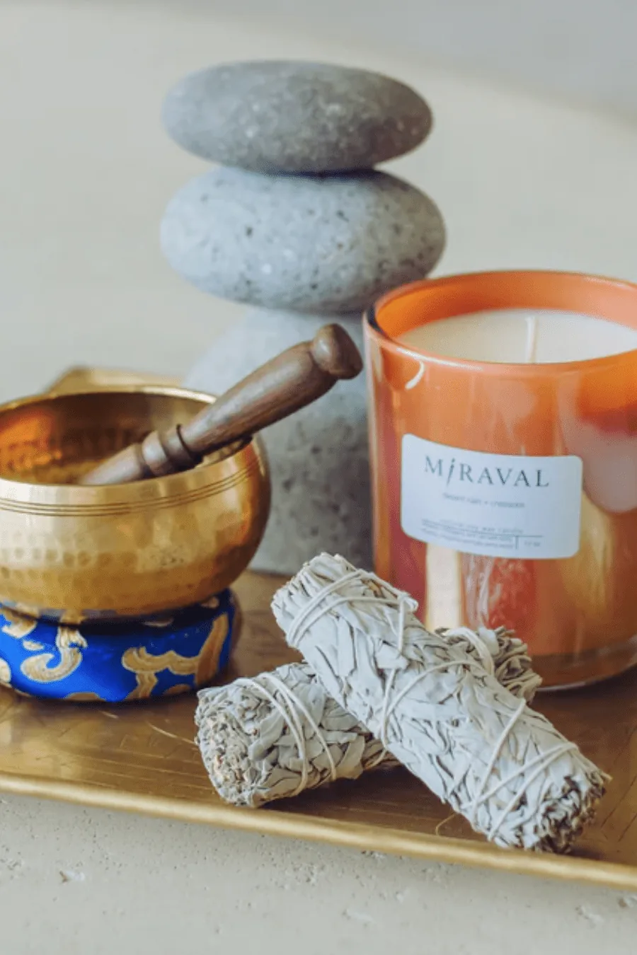 candles and various wellness instruments, such as crystals, bowls, and essential oils, arranged thoughtfully in a calming space at the women’s wellness retreat,