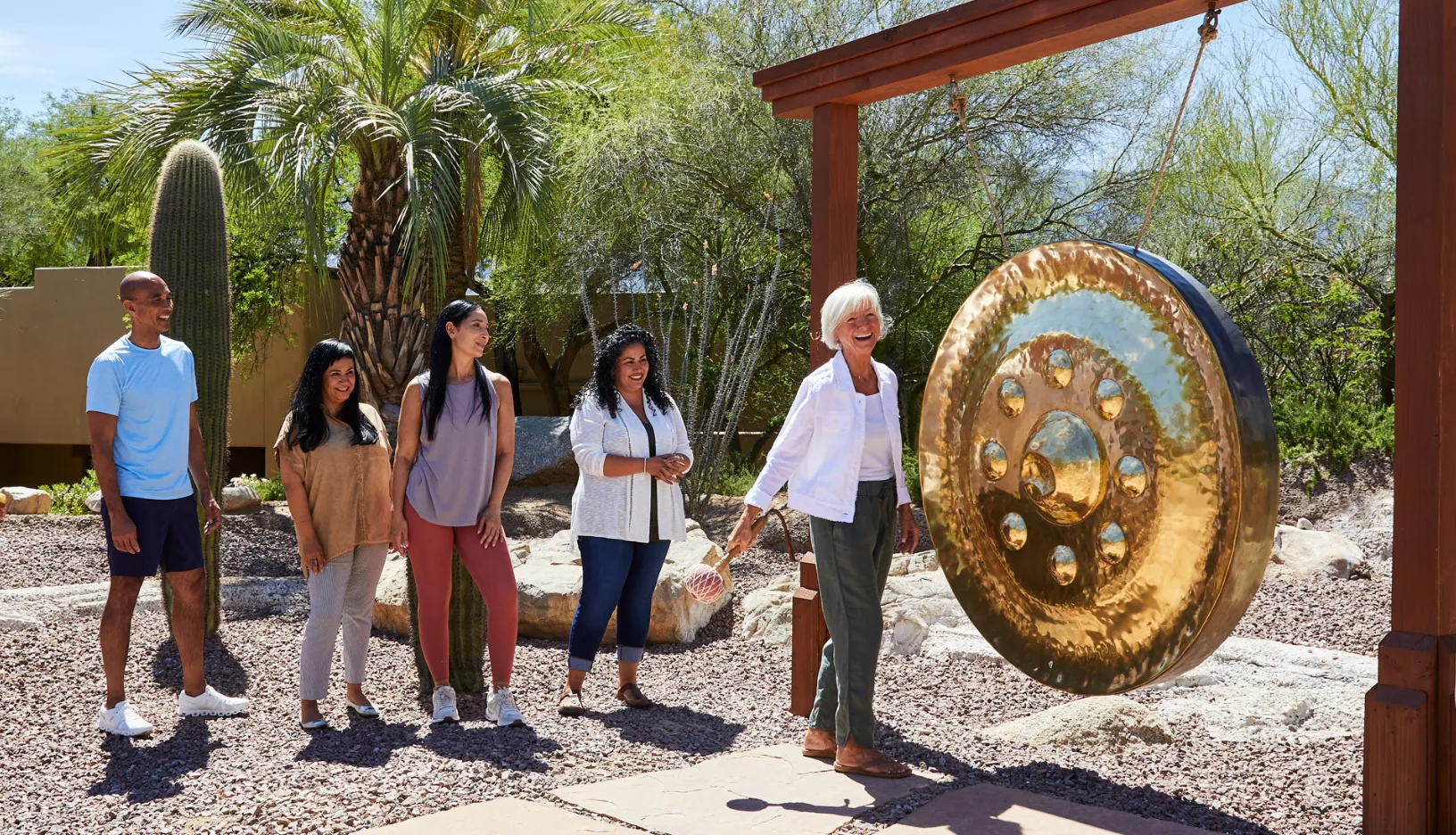 Guests gather around a large gong during a wellness experience at Miraval Arizona.