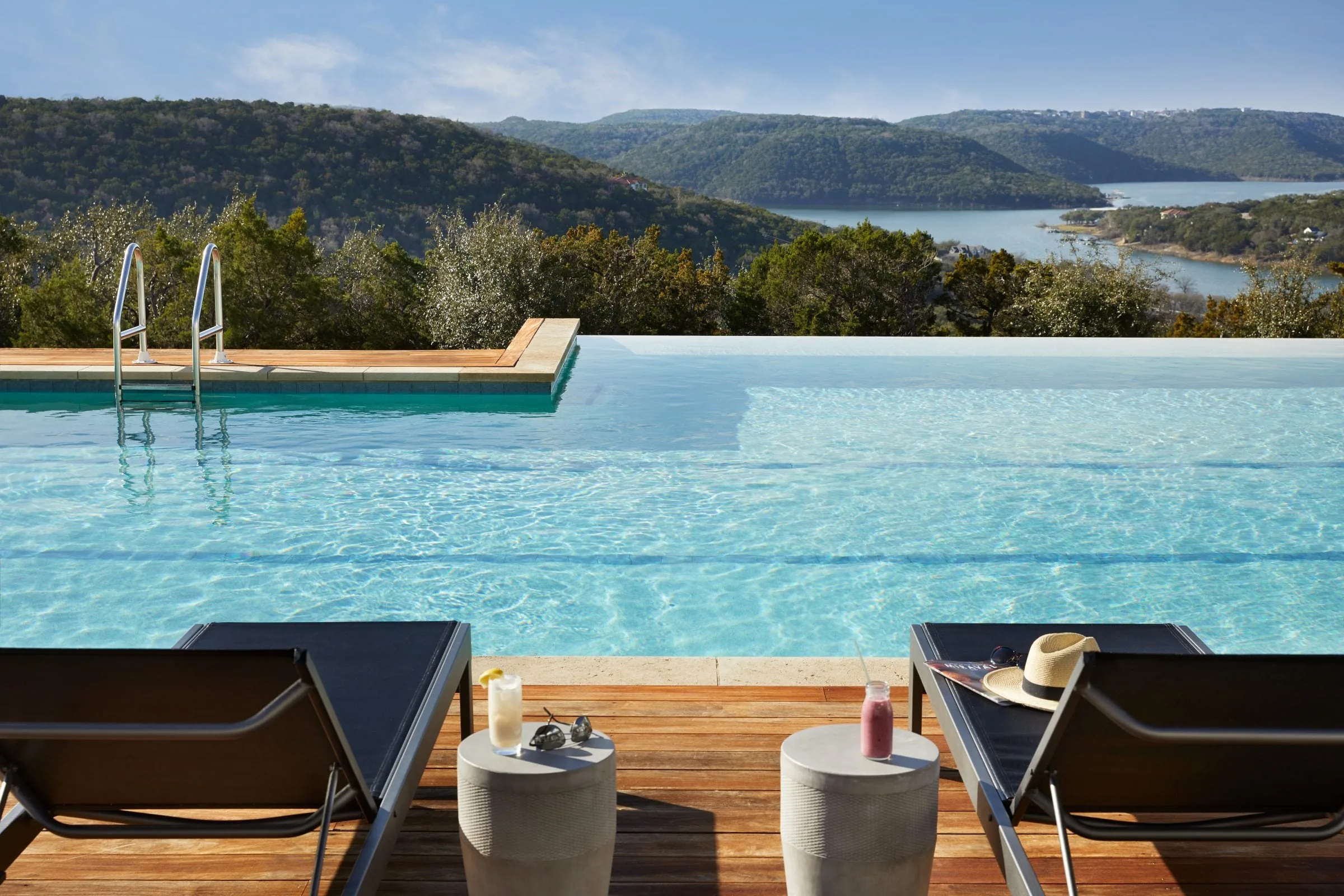 two lounge chair beside pool with ocean view