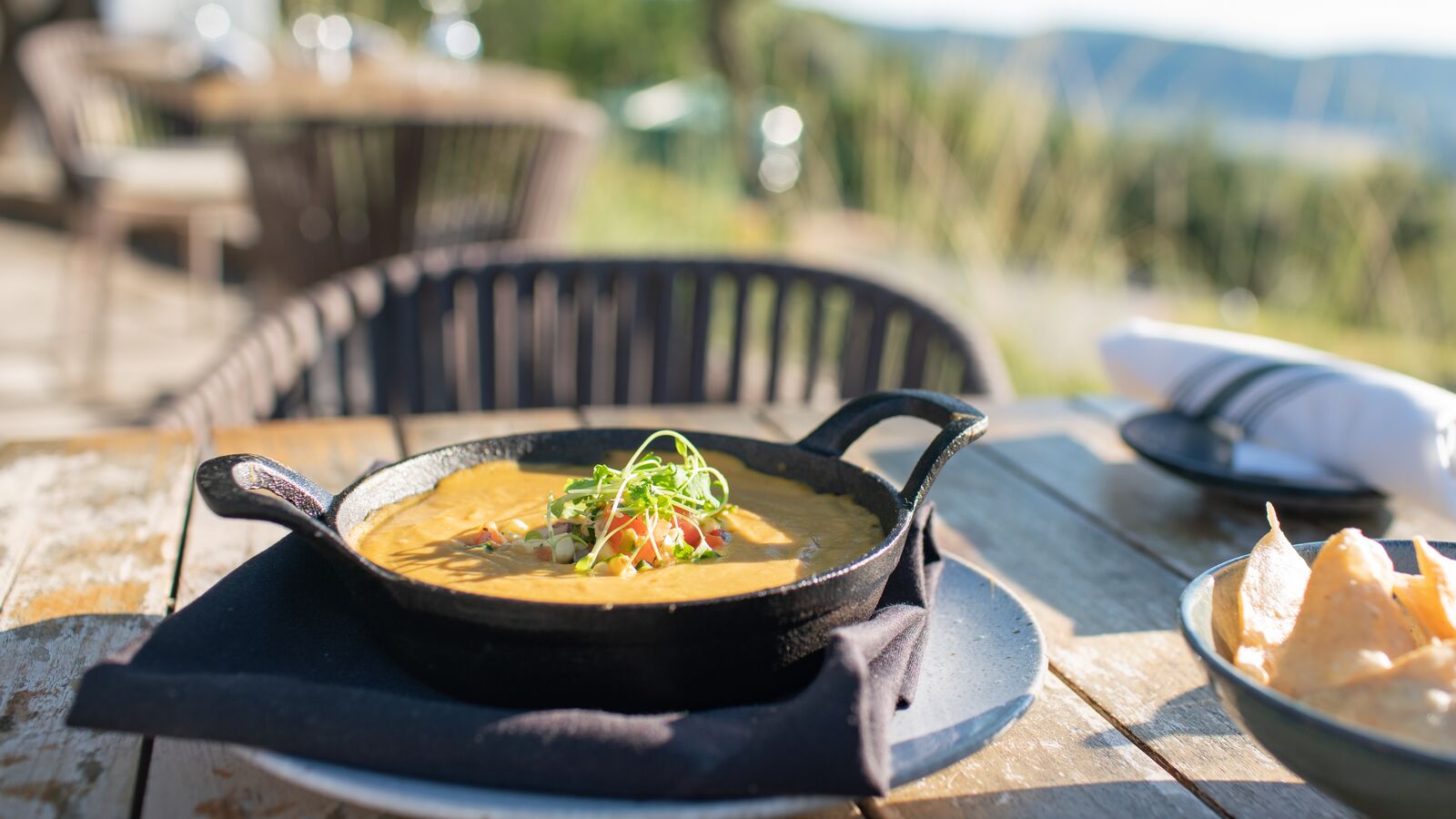 sauce in cast iron with bowl of chips