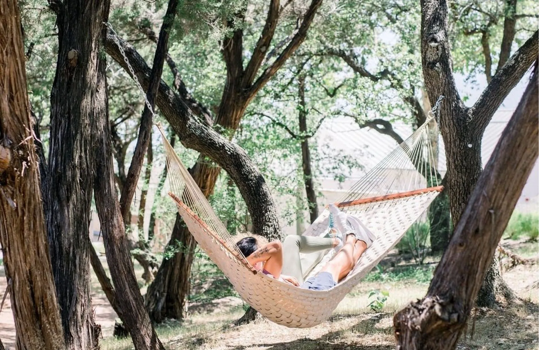 two people relaxing on hammock outside