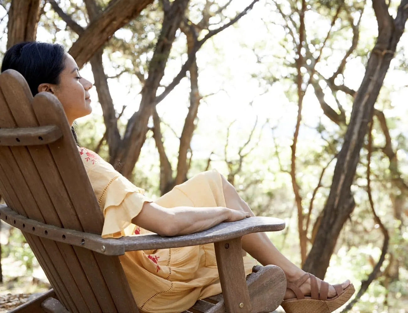 person sitting on bench enjoying the outdoors