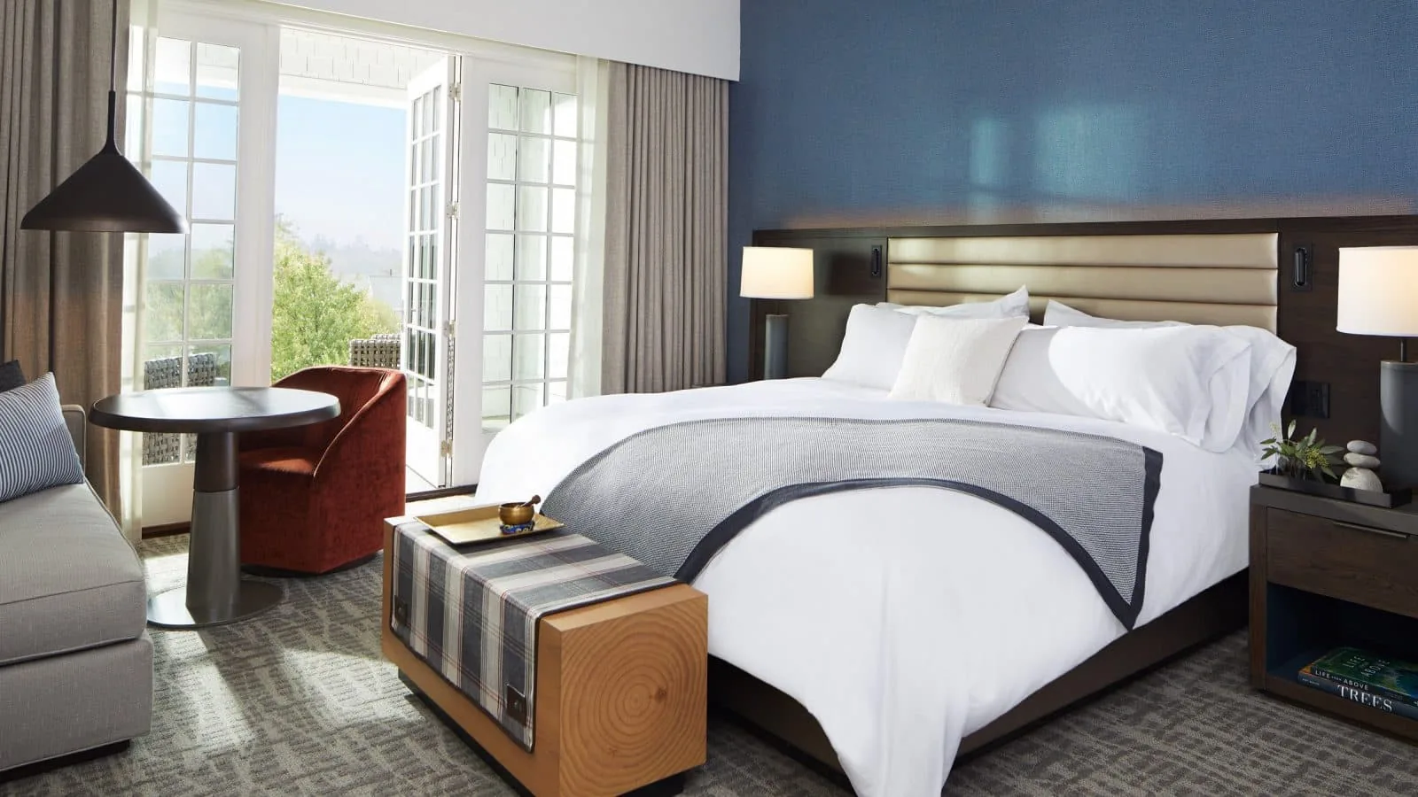 interior of a bedroom with king bed table and couch