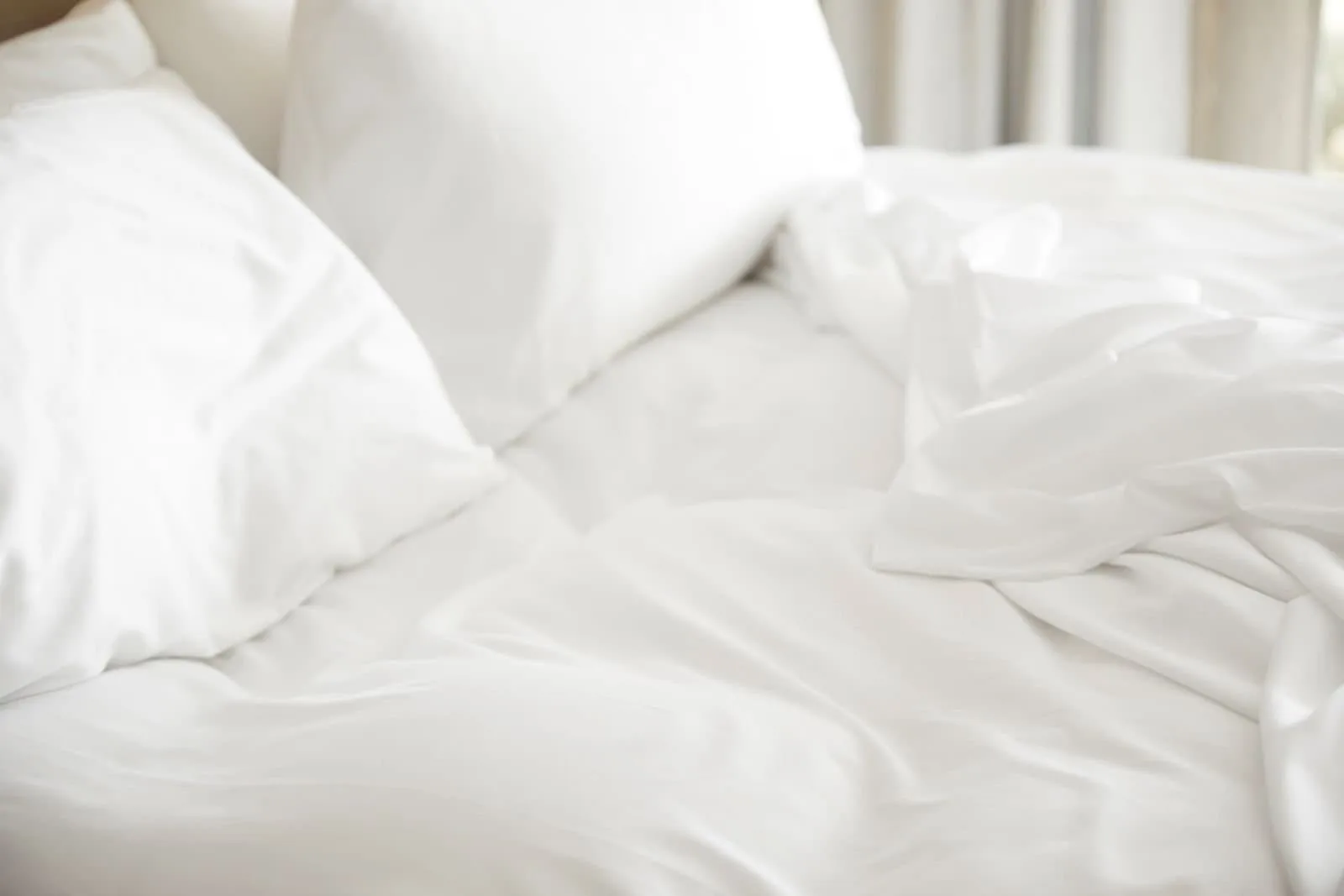 White pillows and blanket on queen bed