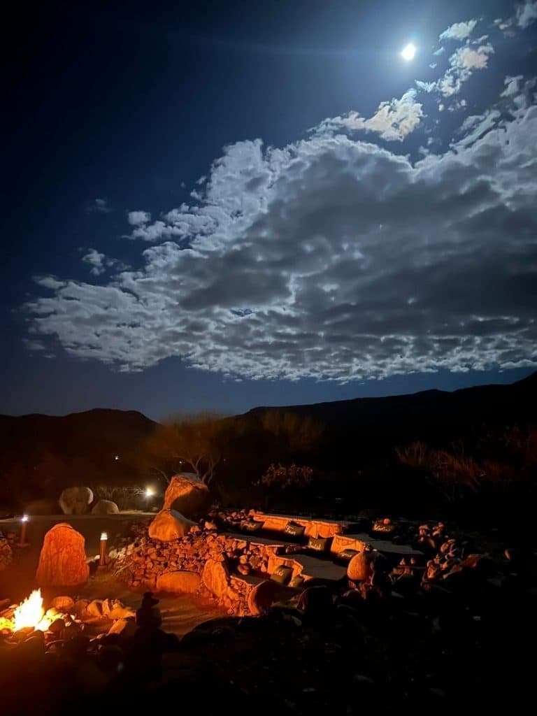 Fire outside in the desert, moon is shining