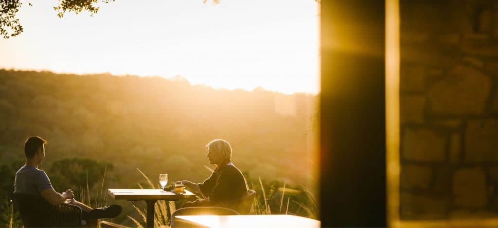 Two people sitting outside on patio