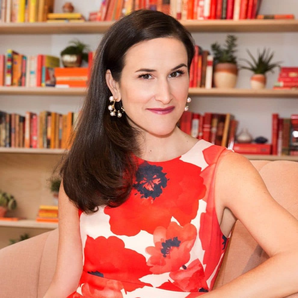 Portrait of Lydia Fenet at home with a bookshelf in background