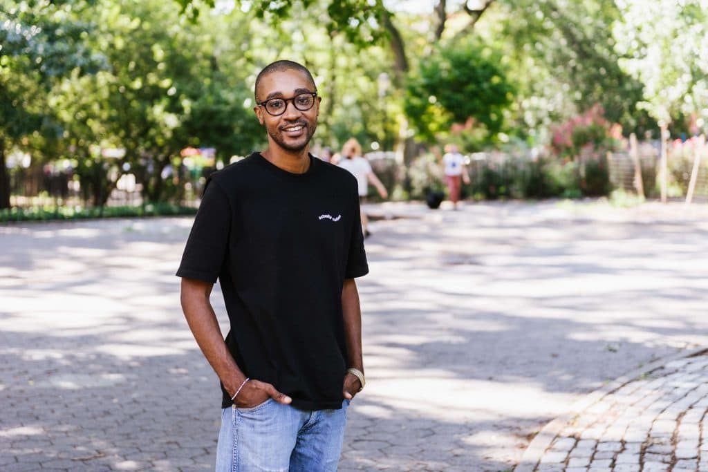 Michael Tennant outside on path with trees in background